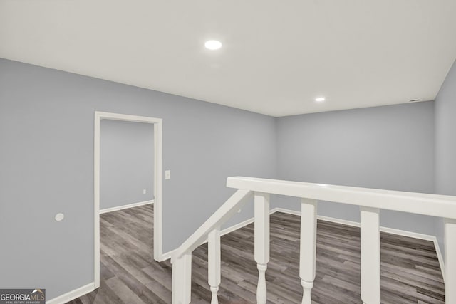 hallway featuring recessed lighting, an upstairs landing, wood finished floors, and baseboards