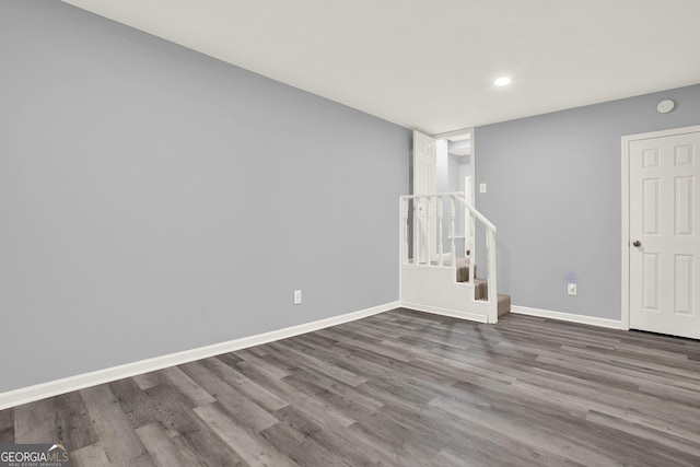 basement with stairway, recessed lighting, baseboards, and wood finished floors