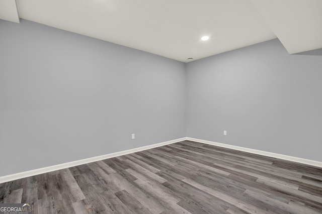 spare room featuring recessed lighting, baseboards, and wood finished floors