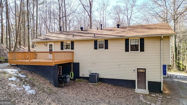 back of house with a wooden deck and central AC unit