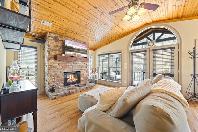 living room with a healthy amount of sunlight, wooden ceiling, a fireplace, and wood finished floors