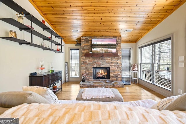 living room with wood finished floors, a healthy amount of sunlight, wooden ceiling, and a fireplace