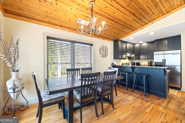 dining room featuring lofted ceiling, light wood-style floors, an inviting chandelier, baseboards, and wood ceiling