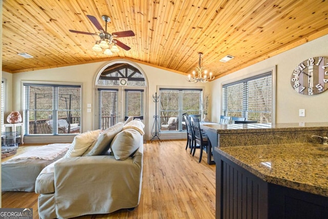 living room featuring visible vents, wood ceiling, vaulted ceiling, light wood-style flooring, and ceiling fan with notable chandelier