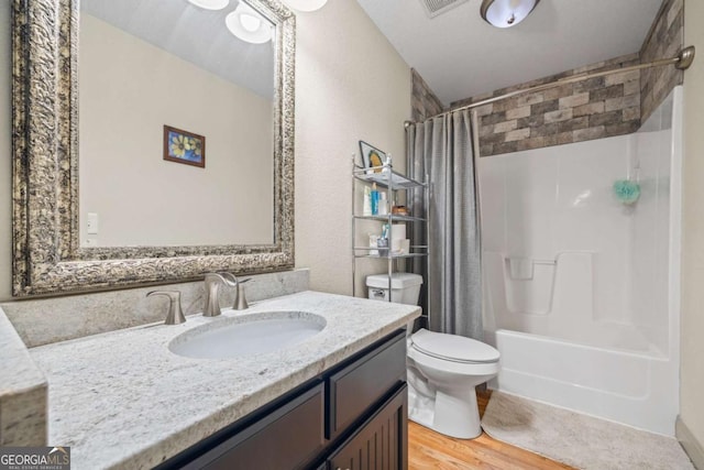 bathroom featuring vanity, shower / bathtub combination with curtain, toilet, and wood finished floors