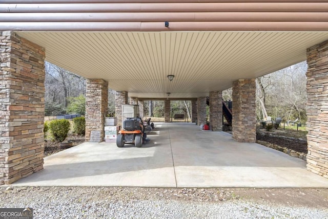 view of patio with a carport and gravel driveway