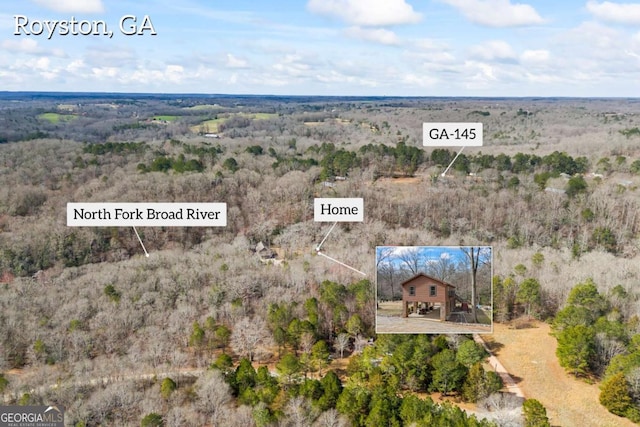 bird's eye view featuring a forest view