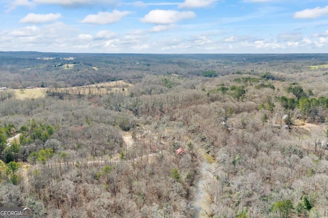 aerial view featuring a wooded view