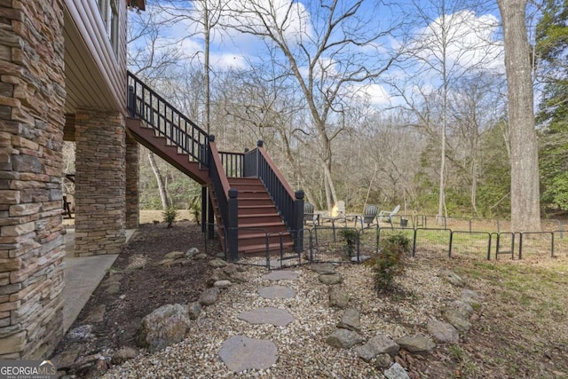 view of yard featuring stairway and fence