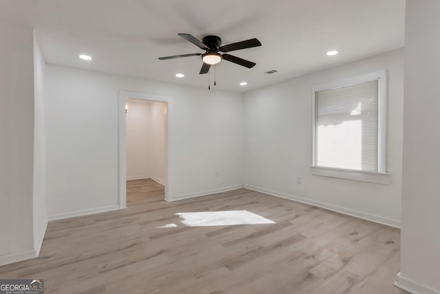 spare room featuring recessed lighting, light wood-style floors, visible vents, and baseboards