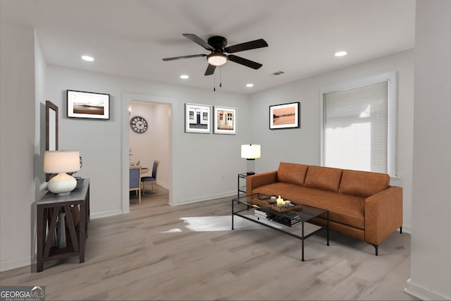 living room with recessed lighting, visible vents, baseboards, and light wood-style flooring