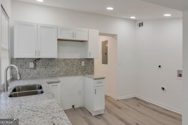 235 Dodd Ave SW, Atlanta, GA 30315 - kitchen with light stone counters, light wood finished floors, recessed lighting, tasteful backsplash, and white cabinets