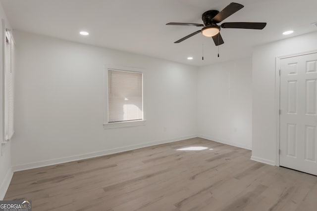 unfurnished room with recessed lighting, light wood-style floors, and baseboards