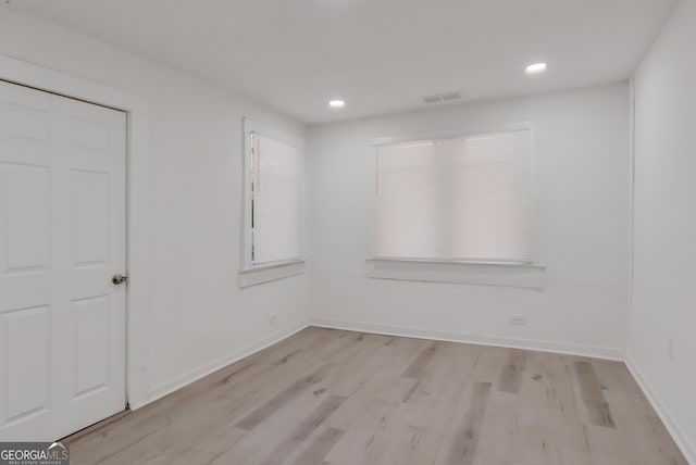 empty room with recessed lighting, visible vents, baseboards, and light wood finished floors