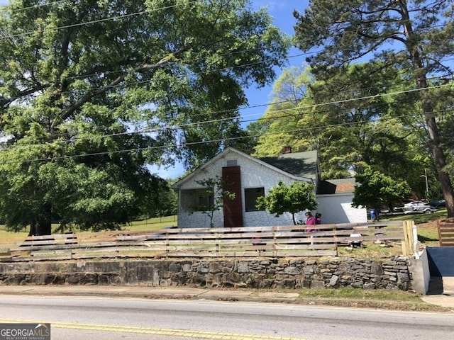 bungalow with a fenced front yard