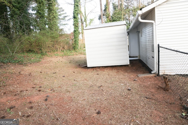 view of side of property with an outbuilding and a storage shed