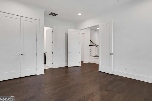 unfurnished bedroom with recessed lighting, visible vents, baseboards, and wood finished floors