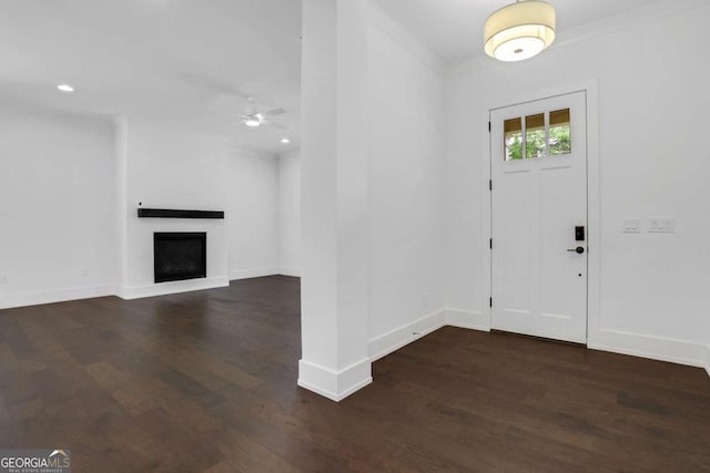 entryway with recessed lighting, baseboards, wood finished floors, and a fireplace