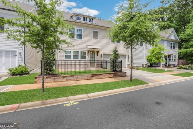 view of front of home featuring a garage, driveway, and fence