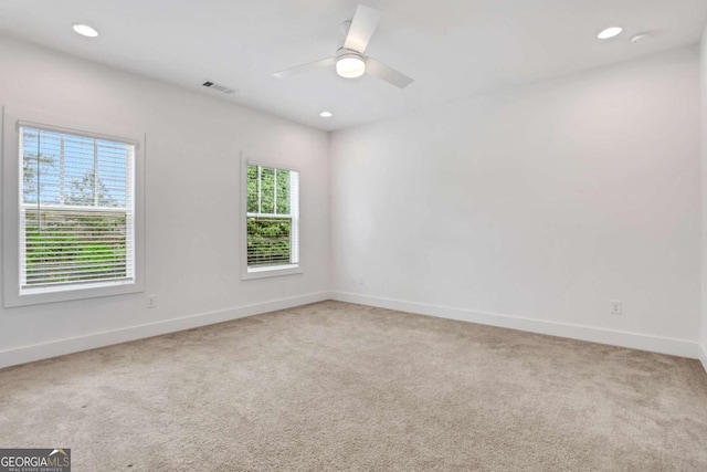 carpeted empty room featuring visible vents, recessed lighting, baseboards, and ceiling fan