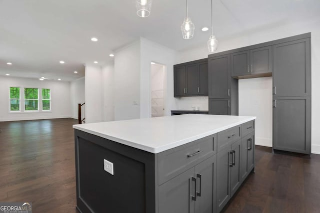 kitchen with a kitchen island, dark wood finished floors, recessed lighting, gray cabinets, and light countertops