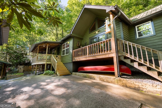 exterior space with stairway and a deck