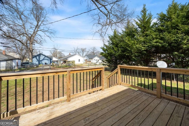 wooden terrace with a lawn, a fenced backyard, and a residential view