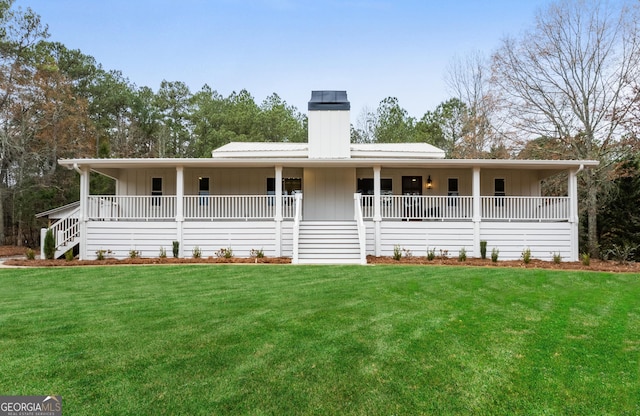 view of front of home featuring board and batten siding, covered porch, and a front yard