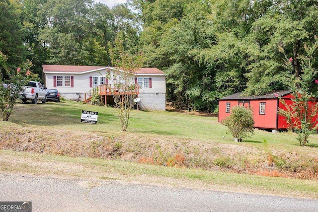 view of yard featuring a wooden deck and an outdoor structure