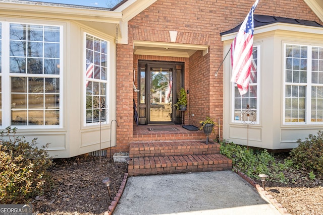 property entrance with brick siding