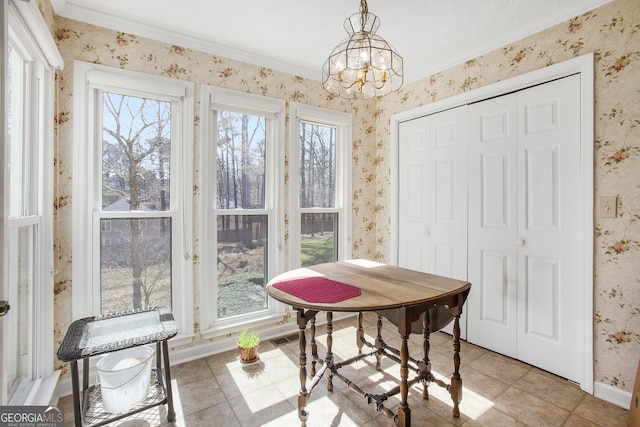 dining space featuring a wealth of natural light and wallpapered walls