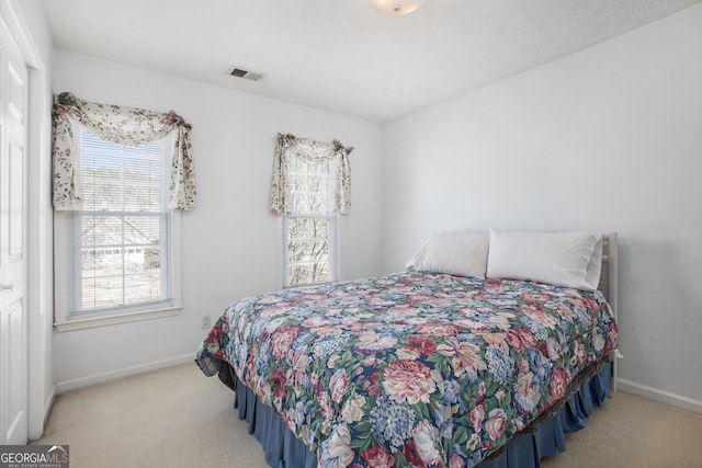 bedroom with visible vents, baseboards, and carpet floors