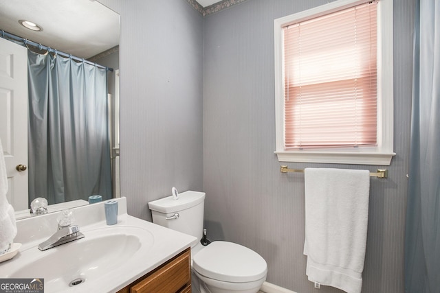 full bathroom with vanity, a shower with shower curtain, and toilet