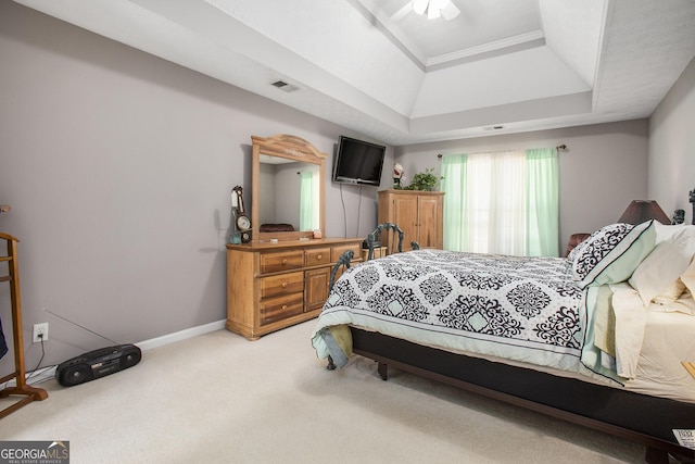 carpeted bedroom with baseboards, a raised ceiling, and visible vents