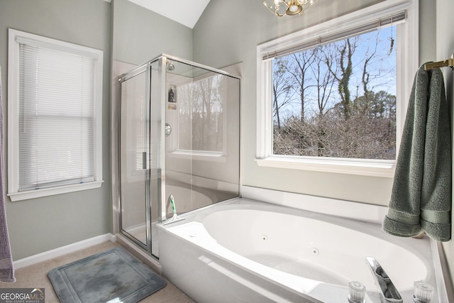 bathroom featuring baseboards, a notable chandelier, a stall shower, and a whirlpool tub