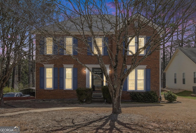 colonial house with brick siding and central air condition unit