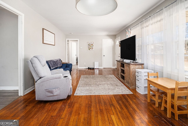 living room featuring baseboards and dark wood-style flooring