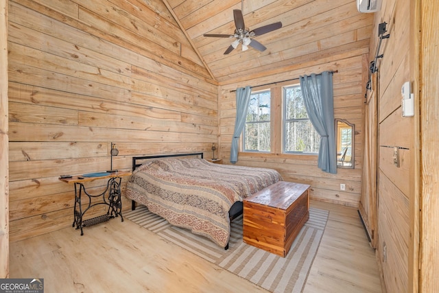 bedroom featuring ceiling fan, lofted ceiling, wooden walls, and wood finished floors