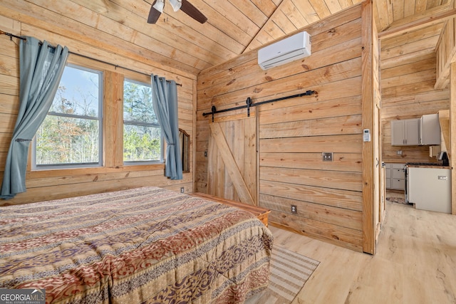 bedroom with a barn door, wooden walls, wood ceiling, and a wall unit AC