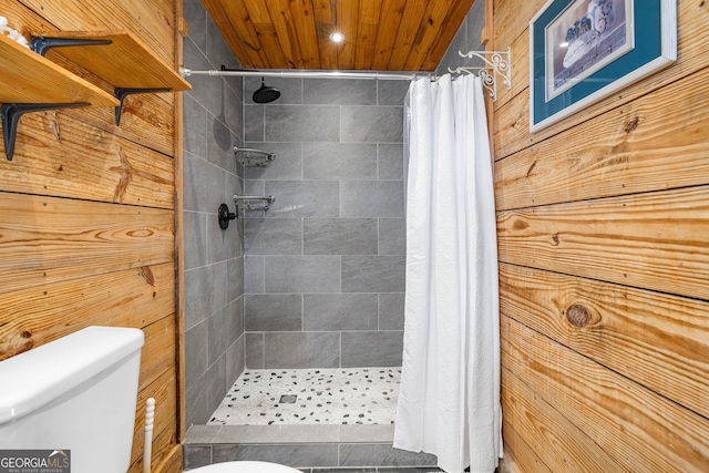 full bathroom featuring toilet, wood ceiling, and a shower stall