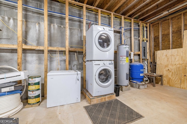 clothes washing area with water heater, stacked washer / dryer, laundry area, and electric panel