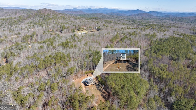 aerial view featuring a mountain view and a forest view