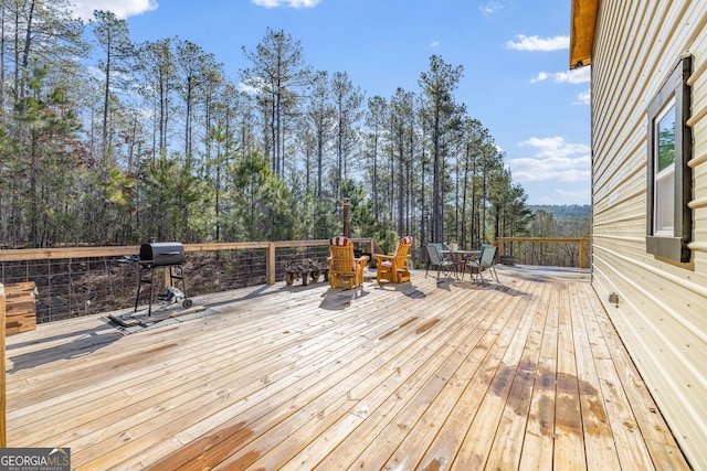 wooden terrace with a grill