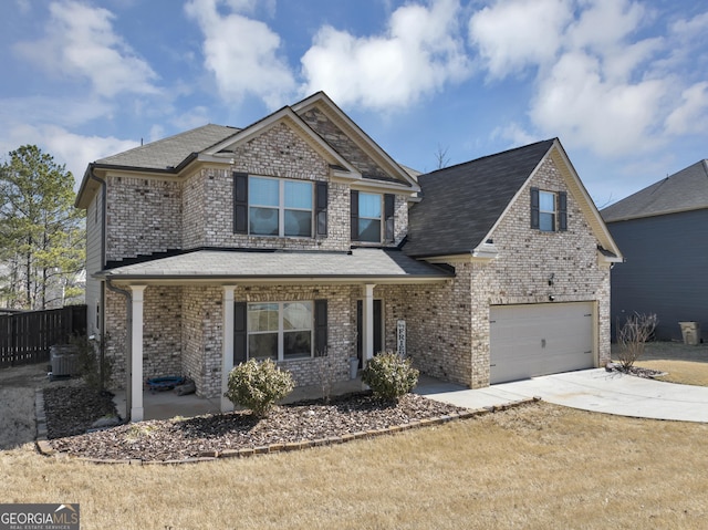 view of front facade featuring brick siding, central air condition unit, driveway, and fence