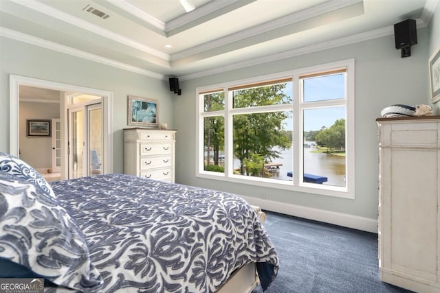 carpeted bedroom with a tray ceiling, crown molding, visible vents, and baseboards