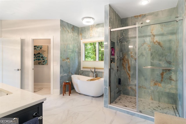 bathroom with a marble finish shower, marble finish floor, vanity, and a freestanding tub