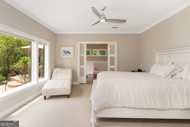 bedroom featuring baseboards, visible vents, ceiling fan, light carpet, and crown molding