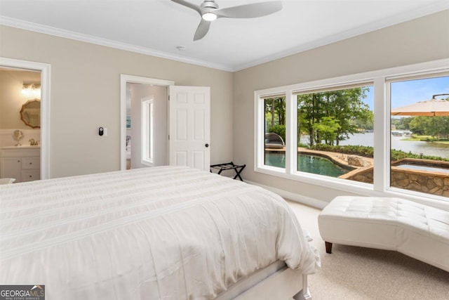 bedroom featuring ensuite bath, crown molding, carpet, and a ceiling fan