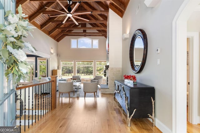 interior space featuring beamed ceiling, plenty of natural light, wood ceiling, and wood-type flooring