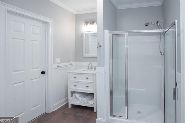 full bathroom featuring vanity, a shower stall, crown molding, and tile patterned floors